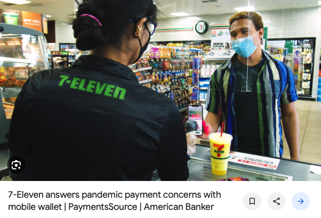 Person at the counter at 7-Eleven using their phone to pay for a drink by showing their Wallet barcode in the 7-Eleven app.
